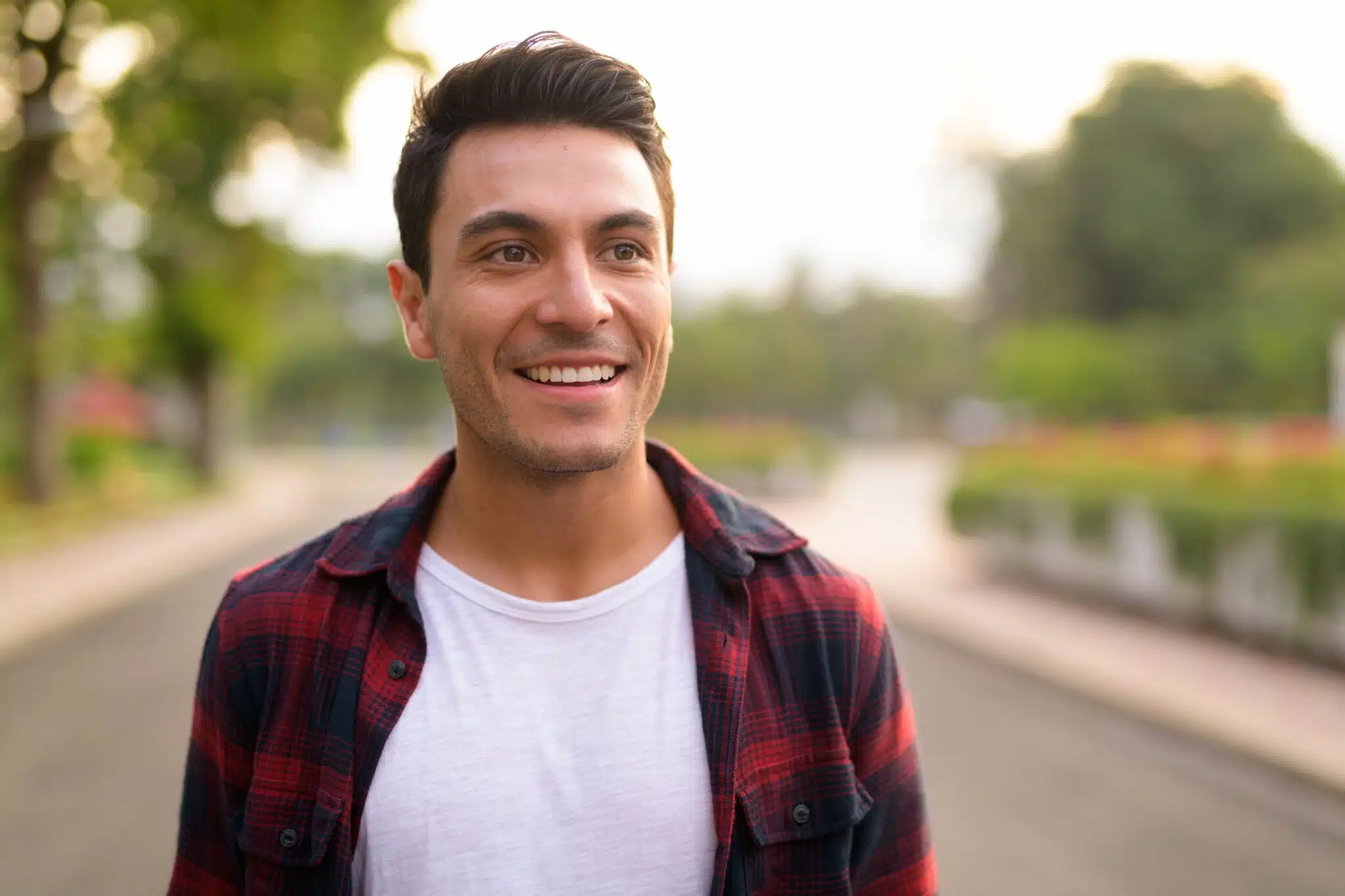 Smiling man outdoors representing the benefits of custom nightguards