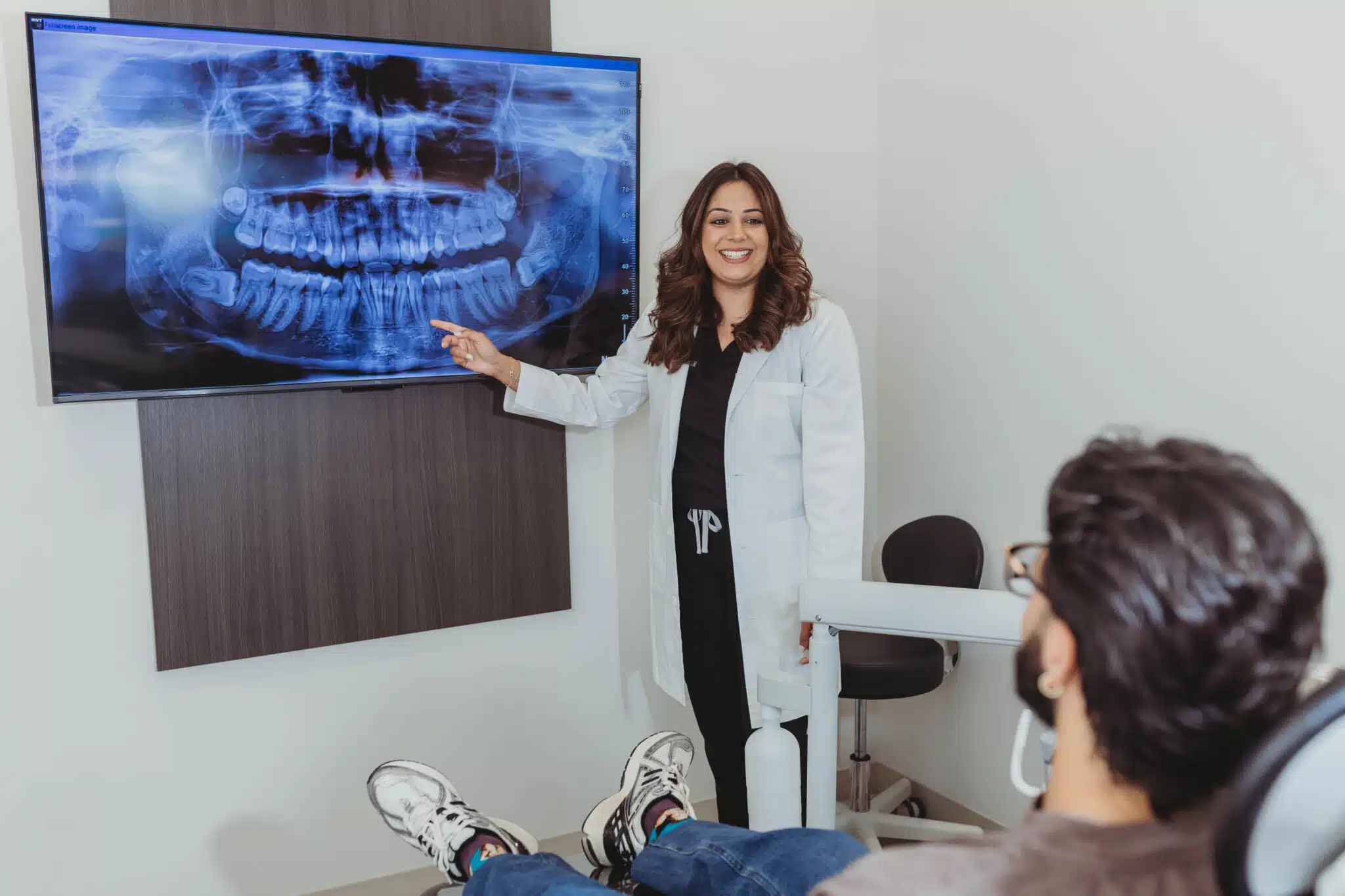 Dentist reviewing digital dental X-rays with patient