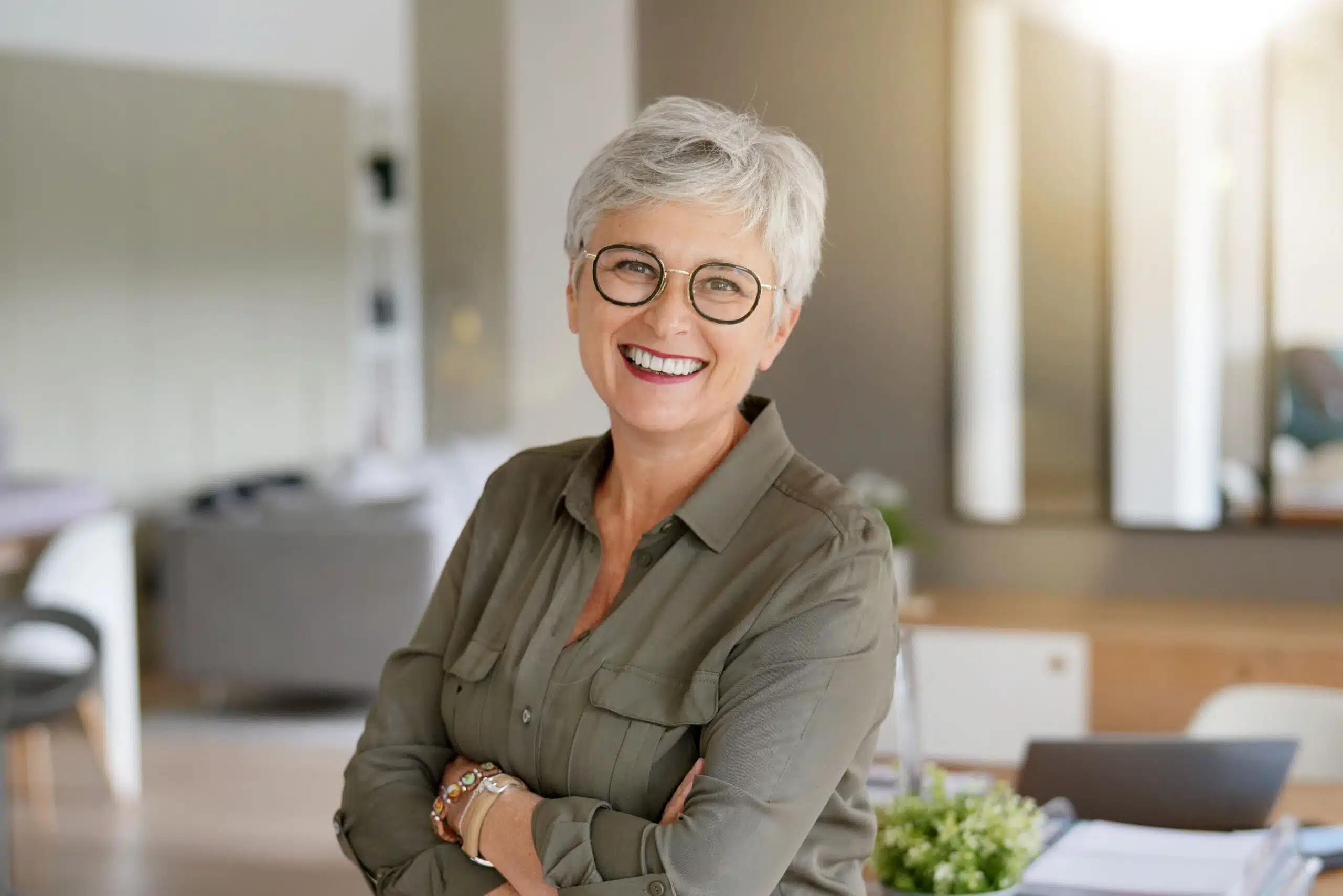 Older woman with short gray hair smiling indoors