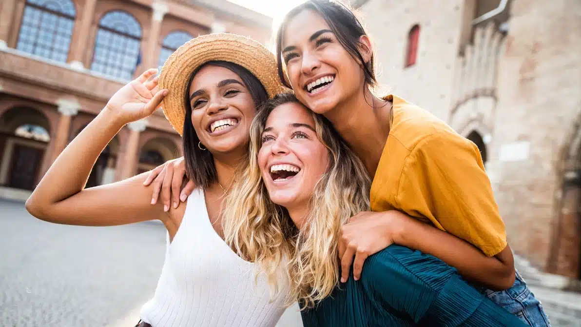 Four women smiling together outdoors