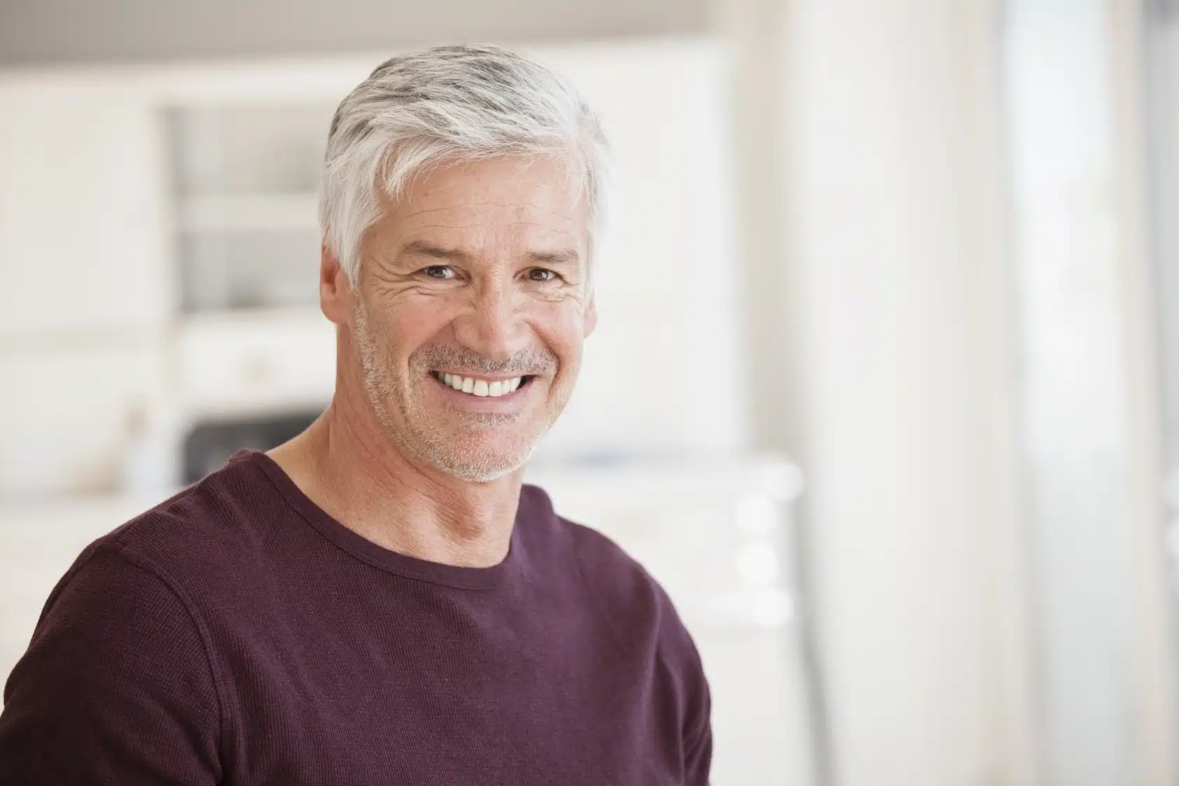 Smiling man representing a healthy, confident smile