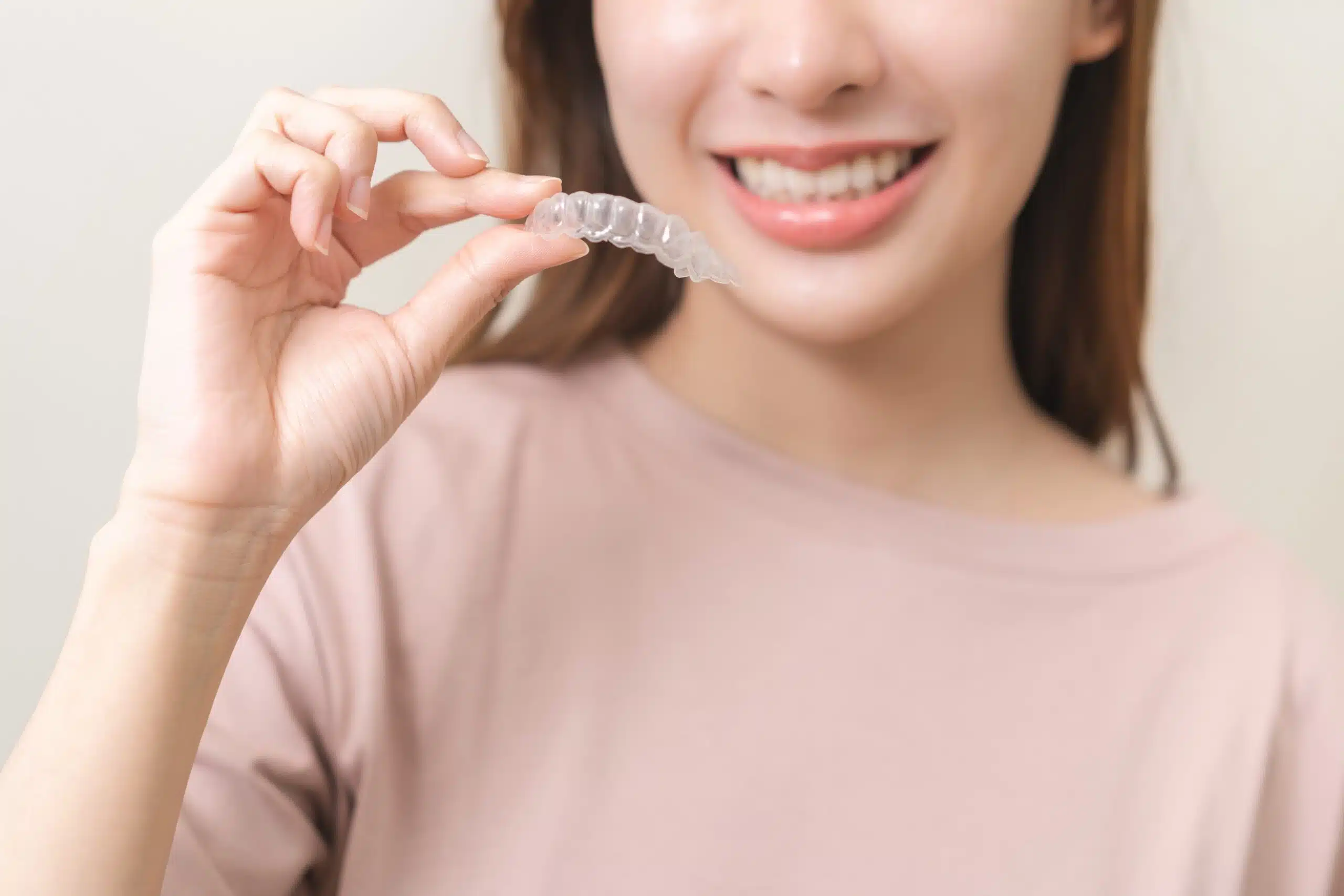 Woman wearing Invisalign clear aligner