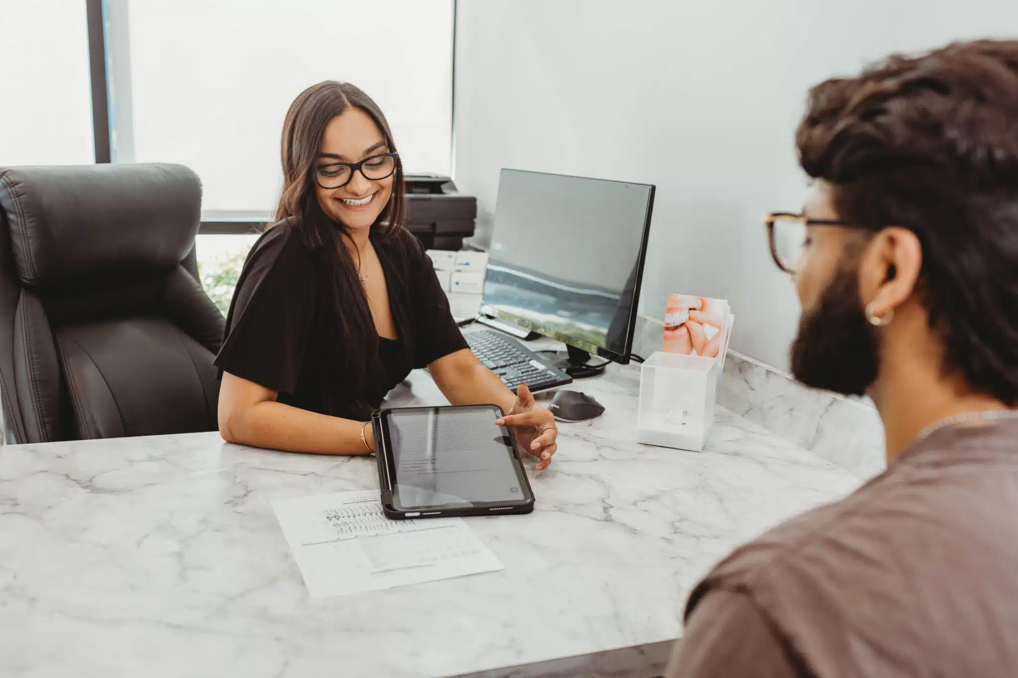 Dental team member discussing membership plan benefits with a patient