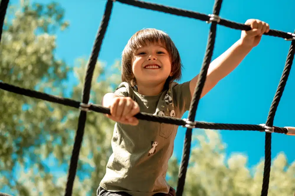 Child playing outdoors while learning the importance of primary teeth