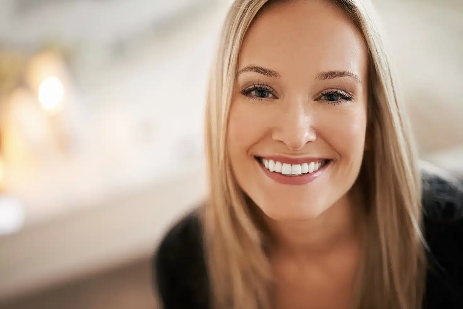 Smiling woman looking directly at the camera, representing a happy and confident individual