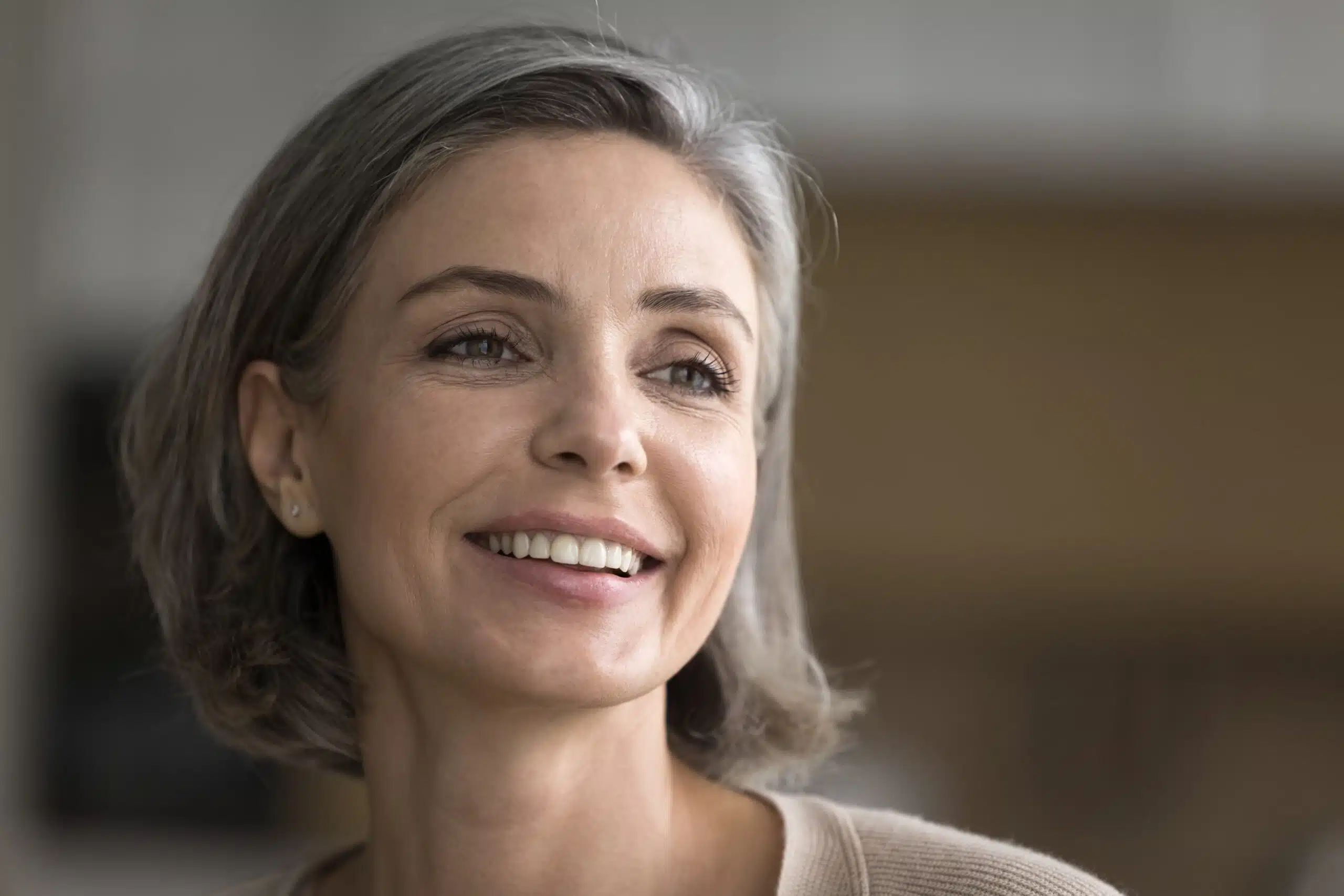 Woman with a natural-looking smile in a home setting